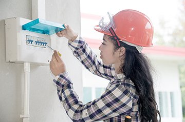Electrician inspecting a residential service panel